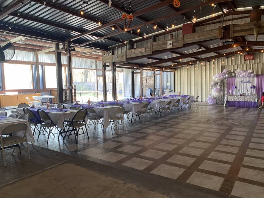 Reception tables with blue accents along the wood walls