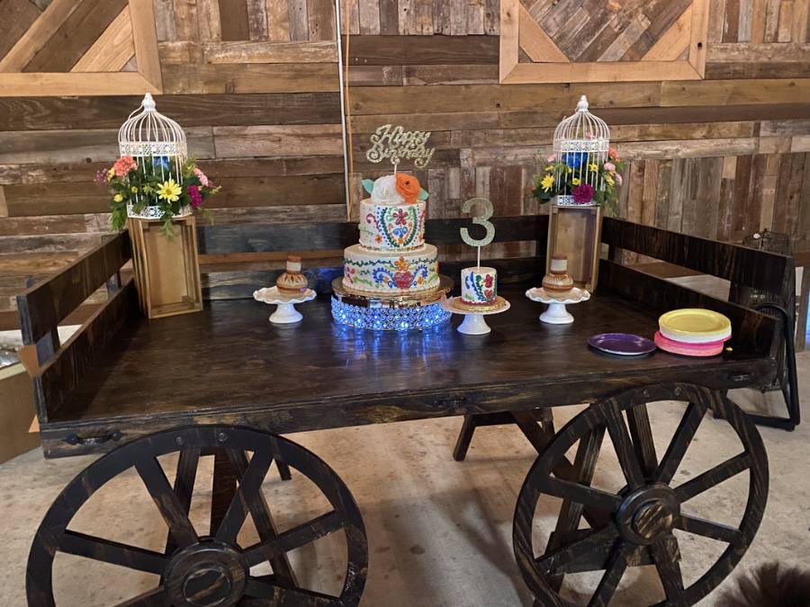 Dessert display on a rustic wooden wagon cart