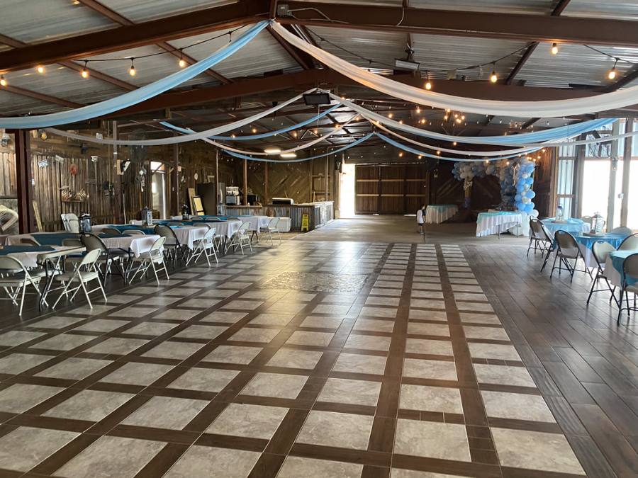 Wide view of the hall with checkered floor and decorated tables