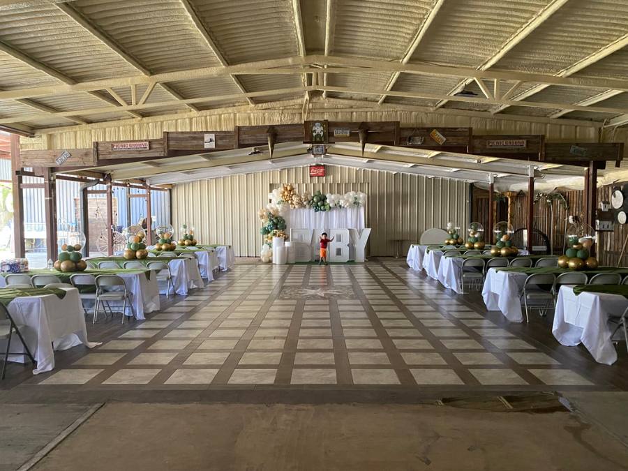 Reception tables with purple and white decor under string lights